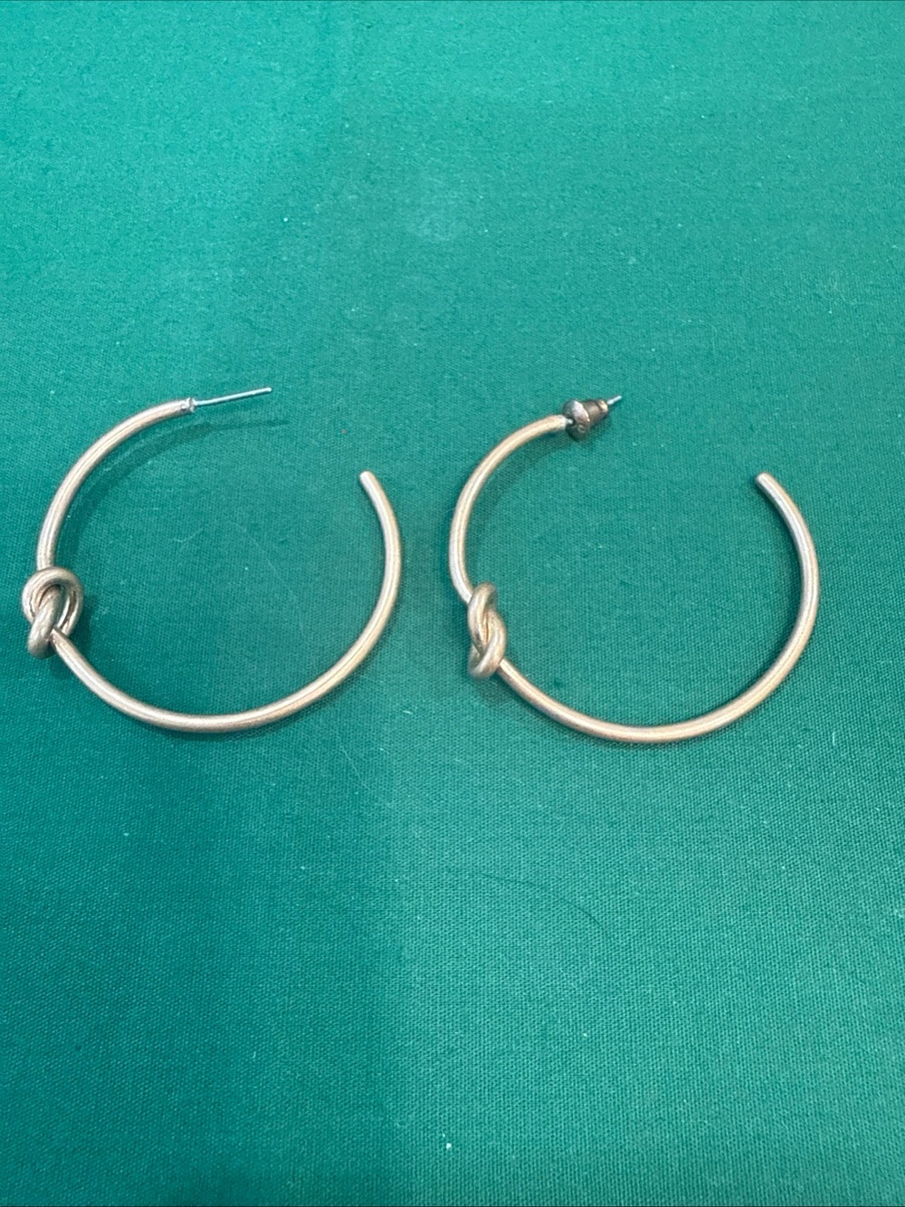 Goldtone Hoop Earrings Feature A Knot On The Lower Curve. 78D
